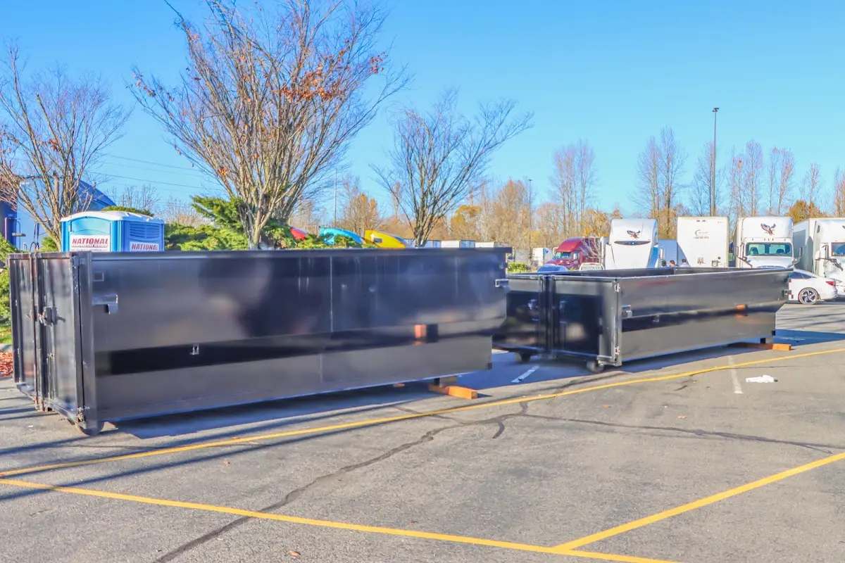 Professional dumpster rental service with roll-off container on residential driveway in Indianapolis